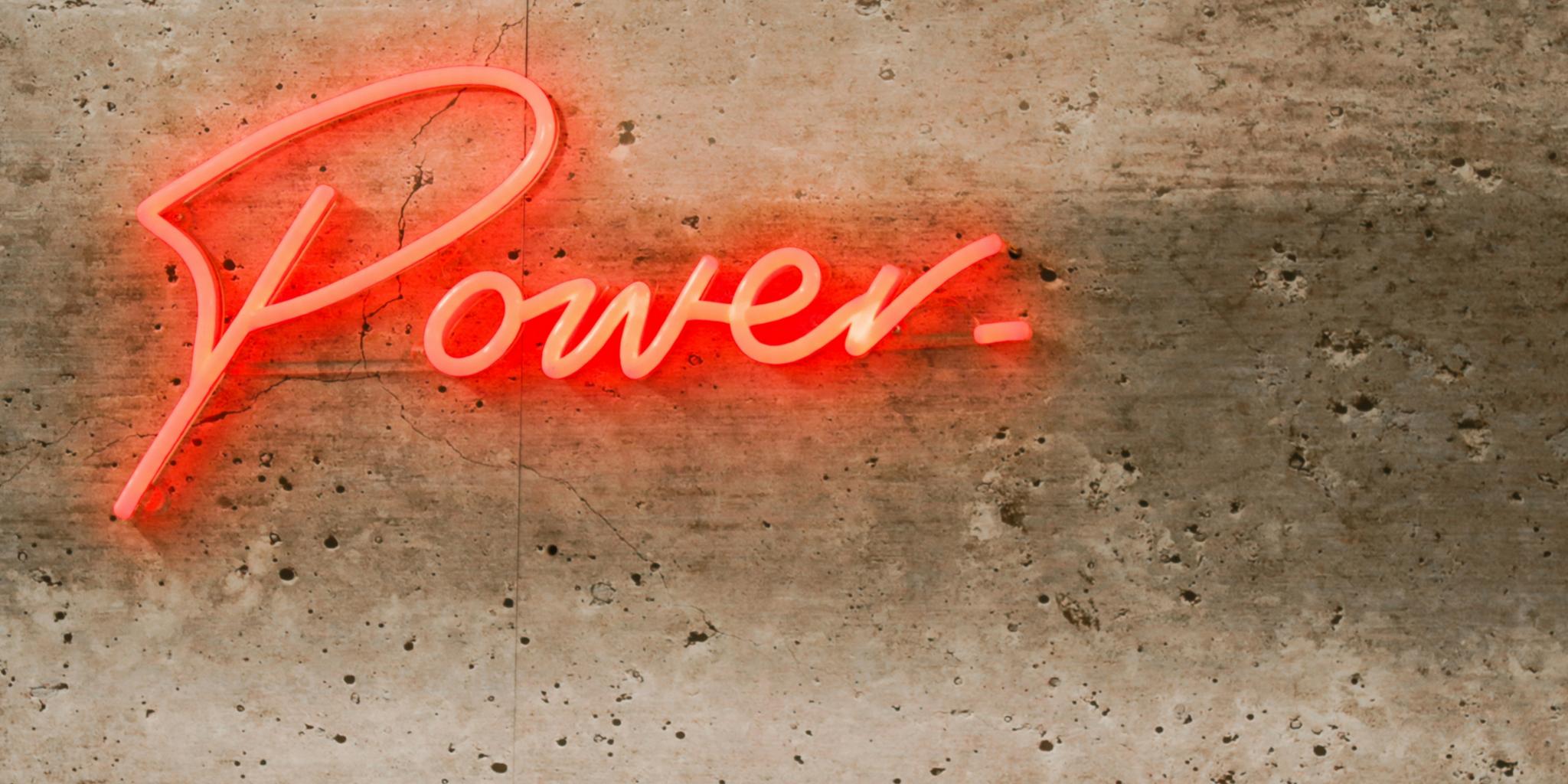 Ein Schriftzug in Leuchtbuchtstaben an der Wand:POWER